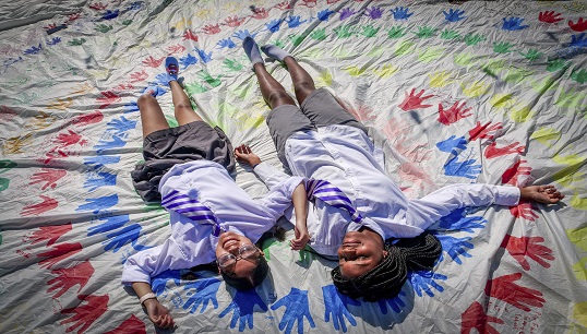 The vision of 'hands around the world' joining together to remove barriers to girls receiving an education was the inspiration for creating a 'rainbow spiral' of children's handprints on one of Maiden's sails. More hands are added during Maiden's voyages. Image: The Maiden Factor Image:The vision of 'hands around the world' joining together to remove barriers to girls receiving an education was the inspiration for creating a 'rainbow spiral' of children's handprints on one of Maiden's sails. More hands are added during Maiden's voyages. Image: The Maiden Factor