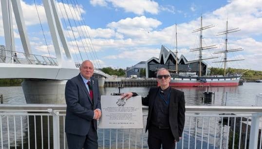 Iain Lindsay (left) at the new plaque with Reverend Joseph O'Donnell, who conducted the blessing. Image: Nautilus International Image:Iain Lindsay (left) at the new plaque with Reverend Joseph O'Donnell, who conducted the blessing. Image: Nautilus International
