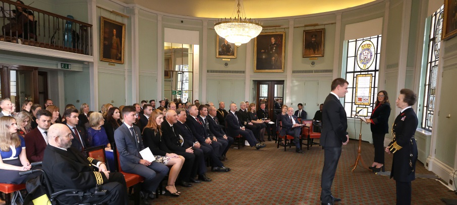 Yacht bosun Ashley West receives his Medal from HRH, The Princess Royal, watched by other awardees and guests, including maritime minister Mike Kane. Image:Yacht bosun Ashley West receives his Medal from HRH, The Princess Royal, watched by other awardees and guests, including maritime minister Mike Kane.