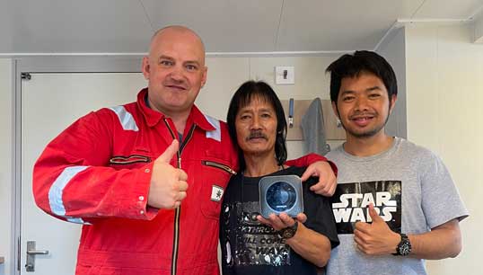 Thumbs up: seafarers with a mi-fi unit. Image: Merchant Navy Welfare Board Image:Thumbs up: seafarers with a mi-fi unit. Image: Merchant Navy Welfare Board