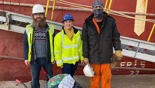 Collaborative efforts: a crew member from MV Federal Tweed was among the seafarers who received gifts, with QVSR chaplain Ruth Campbell (middle) and Stella Maris chaplain Wojciech Holub (left). All images: QVSR Image:Collaborative efforts: a crew member from MV Federal Tweed was among the seafarers who received gifts, with QVSR chaplain Ruth Campbell (middle) and Stella Maris chaplain Wojciech Holub (left). All images: QVSR