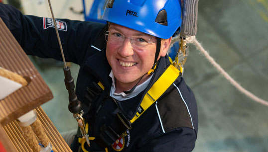Maritime minister Robert Courts climbs the ropes of a pilot ladder used to train employees who board commercial vessels, while on a visit to the Port of London Authority during maritime safety week. Image: PLA Image:Maritime minister Robert Courts climbs the ropes of a pilot ladder used to train employees who board commercial vessels, while on a visit to the Port of London Authority during maritime safety week. Image: PLA