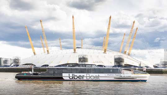 The new Uber Boat by Thames Clippers passes the O2 Arena in its debut on the River Thames. The new joint brand has been created for the naming rights and ticketing partnership. Image: Thames Clippers Image:The new Uber Boat by Thames Clippers passes the O2 Arena in its debut on the River Thames. The new joint brand has been created for the naming rights and ticketing partnership. Image: Thames Clippers