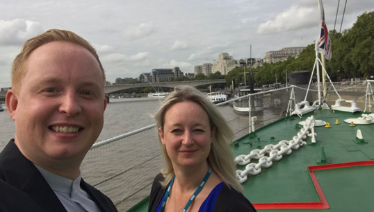 Danny McGowan, chair of Maritime UK's Pride in Maritime Network and Nautilus international organiser, and Chrissie Clarke, Maritime UK's head of diversity and secretary to the Maritime Skills Commission aboard the HQS Wellington where the in-person part of the hybrid event was hosted. Image:Danny McGowan, chair of Maritime UK's Pride in Maritime Network and Nautilus international organiser, and Chrissie Clarke, Maritime UK's head of diversity and secretary to the Maritime Skills Commission aboard the HQS Wellington where the in-person part of the hybrid event was hosted.
