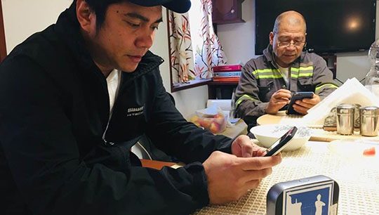 Seafarers enjoying internet access provided by the MiFi project. Image:Seafarers enjoying internet access provided by the MiFi project.
