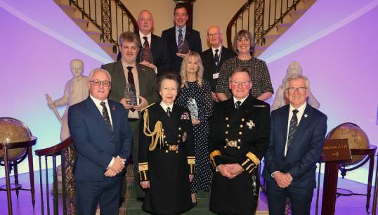 Image:Iain Lindsay, (back, top left), was honoured with a MNWB award (Team Member of the Year) for services to seafarer welfare. The other recipients were: Back (L-R beside Mr Lindsay): Alexander Campbell; CEO Queen Victoria Seafarer's Rest (Innovation Award); Peter Wells of the Seafarers' Christian Friend Society (Volunteer of the Year Award). Middle (L-R): John Cousley of the Department for Transport (Most Collaborative Organisation); Sandra Welch, CEO of the Seafarers Hospital Society (Lifetime Achievement Award); Vikki Muir, head of Charitable Giving at Trinity House (Team Member of the Year). Front (L-R): Stuart Rivers, chief executive of the MNWB; HRH The Princess Royal, (patron of the MNWB); Captain Sir Ian McNaught, MNWB president; Captain Andrew Cassels, MNWB chair. Image: MNWB
